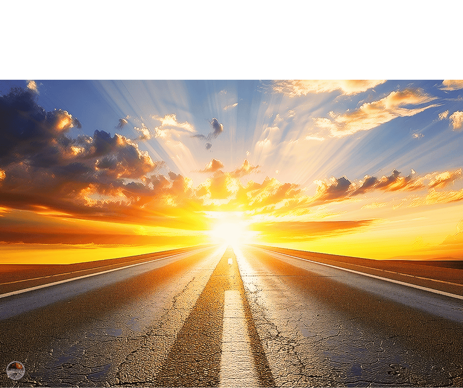 A road leading toward a bright sunrise with rays of light and colorful clouds.